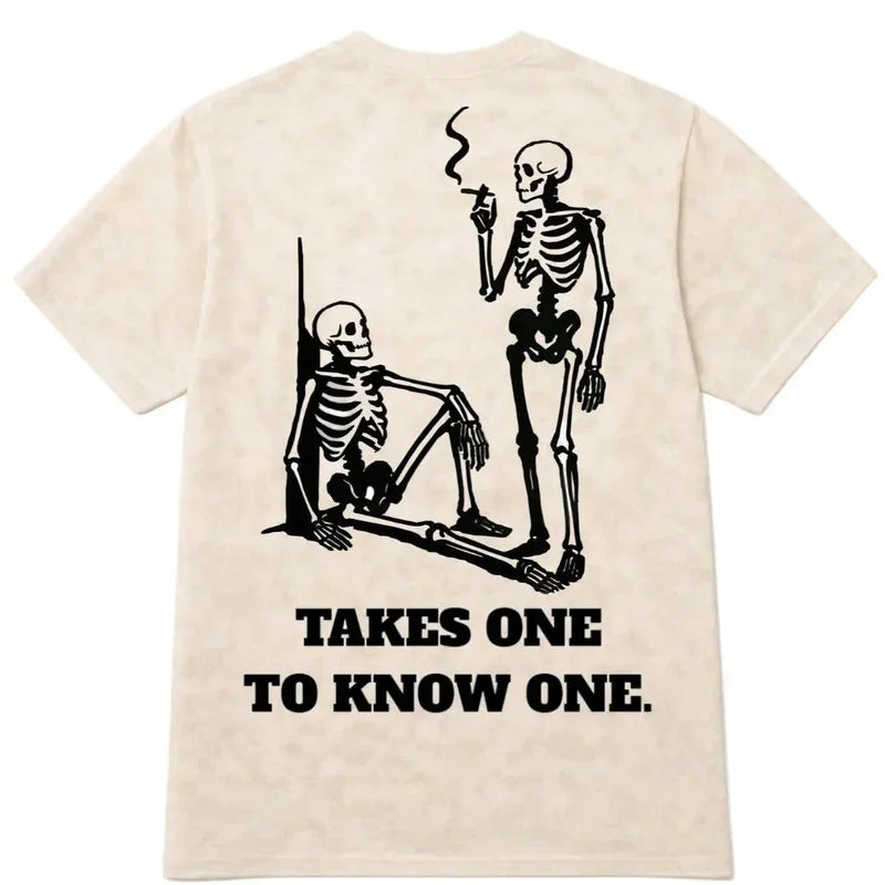 House of Paper Clothing beige shirt with two skeletons and 'Takes One to Know One' text on back